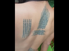 Slave May is showing her tattoos next to the swimming pool