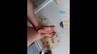 Washing dirty feet in the shower 