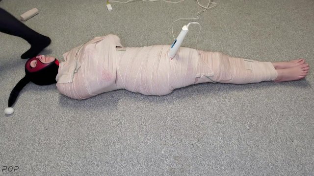 Watch Bondage Video:Harley Quinn wrapped in layers of mummification bondage then teased with a wand & made to cum