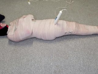 Harley Quinn wrapped in layers of mummification bondage then teased with a wand & made to cum