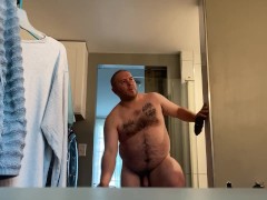 Fat guy getting ready for shower