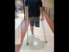 Amputee guy walking with crutches