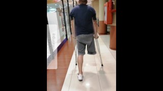 Amputee guy walking with crutches