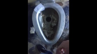 Taking a leak in a nasty outdoor public bathroom 