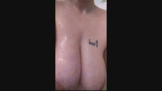 Soaping up my natural huge tits in the shower!