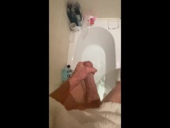 Horny big cock guy wanking in the bath, cumming in bathwater over feet, masturbating uncut big dick