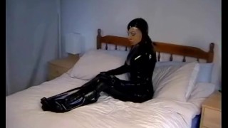 Cute girl in black latex catsuit with mask makes self bondage in rubber vacuum sleepbag - part 1