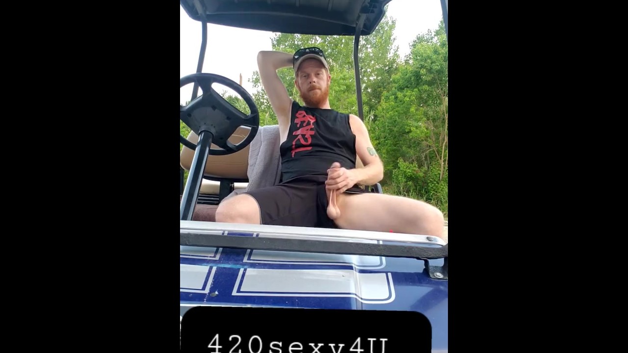 Hairy ginger showing off dick outdoors on golf cart