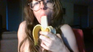 girl with cute glasses sucks banana