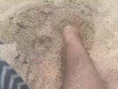 rubbing my feet in the sand on the beach 