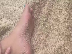 rubbing my feet in the sand on the beach 