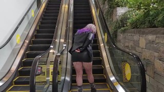 On A Public Escalator Milf In A Miniskirt Rubs Her Pussy
