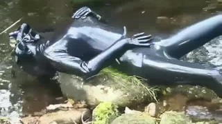 Outdoor Walk In The Woods And River Bath While Wearing A Black Latex Catsuit And A Rubber Gas Mask