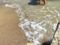 Alice is relaxing on the sea on a wild beach with a butt plug in the ass