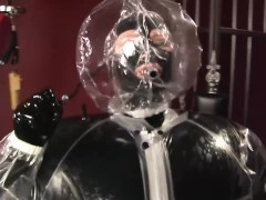 Blonde girl in black latex catsuit full encased in inflatable rubber and full body plastic suit