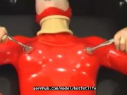 Preview 2 of Sexy girl encased in red rubber catsuit loves medical games with mouth spreader and nipple clamps
