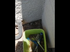 Peeing in a bucket outside
