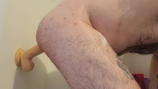 Riding a huge dildo in the shower 