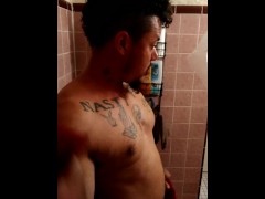 Sexy guy taking shower at the gym