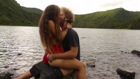 Horny couple pleasuring each other and making love passionately at a volcanic crater lake