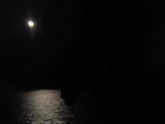 Woman dildo fucks pussy in moonlight by the ocean