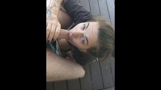 Little Tattooed Cutie Sucking His Cock For The Neighbors On The Porch