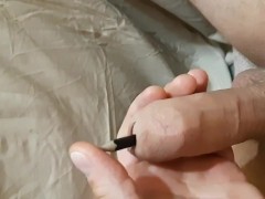 Pencil is deep in the cock peehole. Copious cumming