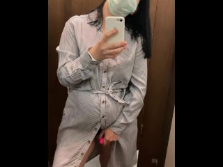 Pregnant beauty masturbates in a clothing store and tries on dresses