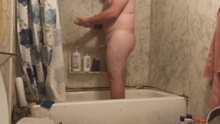 Fat guy jerks dick in shower and swallows own cum