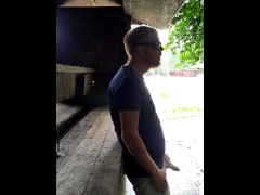 Red headed guy playing with dick outside in the rain while people drive by