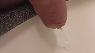 close up pee in sink. uncutted