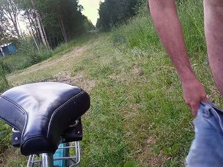 Naked cyclist on a forest road