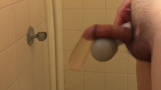 Pissing with electric massager stimulation with condom on.