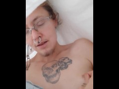 Trans in medical gown plays with their nipple