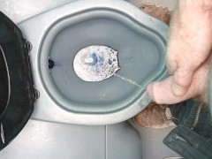 Guy pissing in building sites toilet 