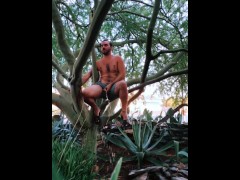 Nudist Hippie peeing from a tree