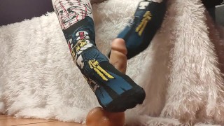 Girl in socks makes footjob on a big dildo