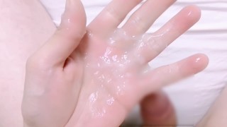 Massive semen release into the hand holding the penis, The palm is covered with semen