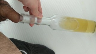 Filling up a wine bottle with piss