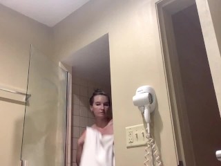 See this HOT big titty DD blonde MILF shower and apply makeup in her hotel