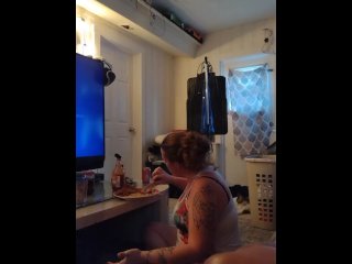 Pretty girl in night dress eats chicken wings and macaroni and cheese