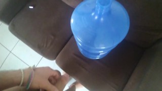 Masturbating in the Bottle (Galão) of water.