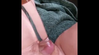 Stretching her pussy with a glass dildo