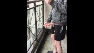 Skinny exhibitionist shows boner on public Toronto balcony while smoking