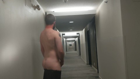 Cumming in hotel hallway