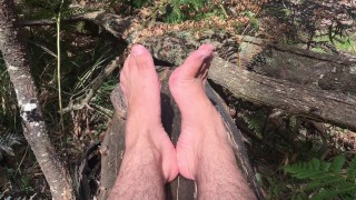 In the deep bush land where no one goes is a man playing with his extra long toes - MANLYFOOT