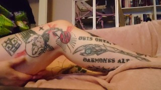 Putting body lotion on my tattooed legs