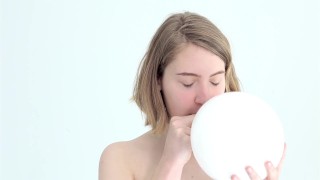 looner babe blowing and popping her first balloon