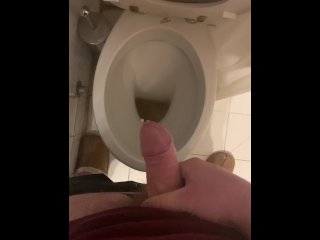 a guy pisses and then masturbates in the bathroom, cumming with his nice cock all over the place
