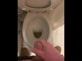 a guy pisses and then masturbates in the bathroom, cumming with his nice cock all over the place